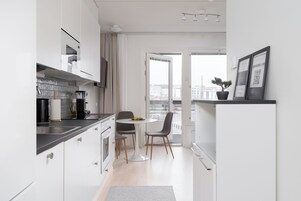 Deluxe Condo, Balcony, City View | Premium bedding, laptop workspace, blackout drapes, iron/ironing board