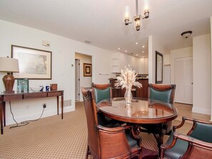 Enjoy meals in this elegant dining area with a round table and comfortable chairs.