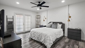 A bedroom with a bed, a desk, a wardrobe, and a ceiling fan. - Newly Remodeled Home @ the Omni at Rancho Las Palmas in Rancho Mirage! (Rancho Mirage)