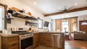 A modern kitchen with a central island, built-in oven, and stainless steel appliances. - Pac. Street Studio: Style & space in heart of town (Telluride)