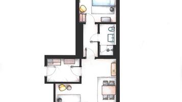 A floor plan of a hotel room with a bed, a desk, a chair, a small table, and a bathroom.