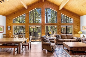 A spacious interior with a high ceiling, large windows, and a wooden interior. - Solitude in the Cedars, Spacious Mountain Home (Shaver Lake)