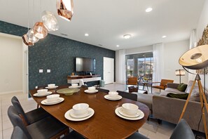 Enjoy meals in the dining area with a flat-screen TV and comfortable seating.