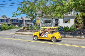 A yellow vintage car parked on a street with a building in the background. - Close to Bike Path 1 Mile to Beaches! (South Chatham)