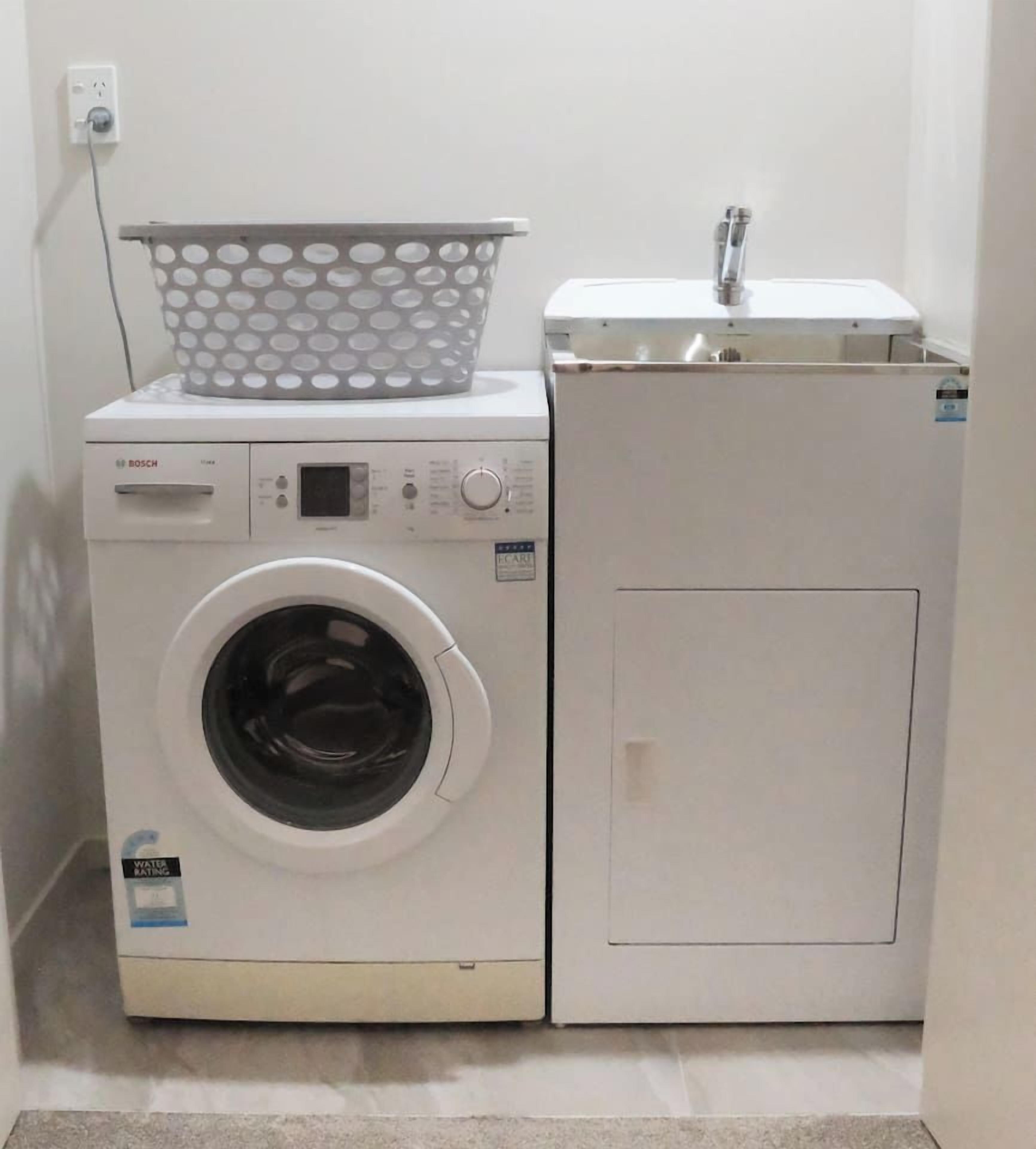 A Bosch washing machine and dryer in a laundry room.