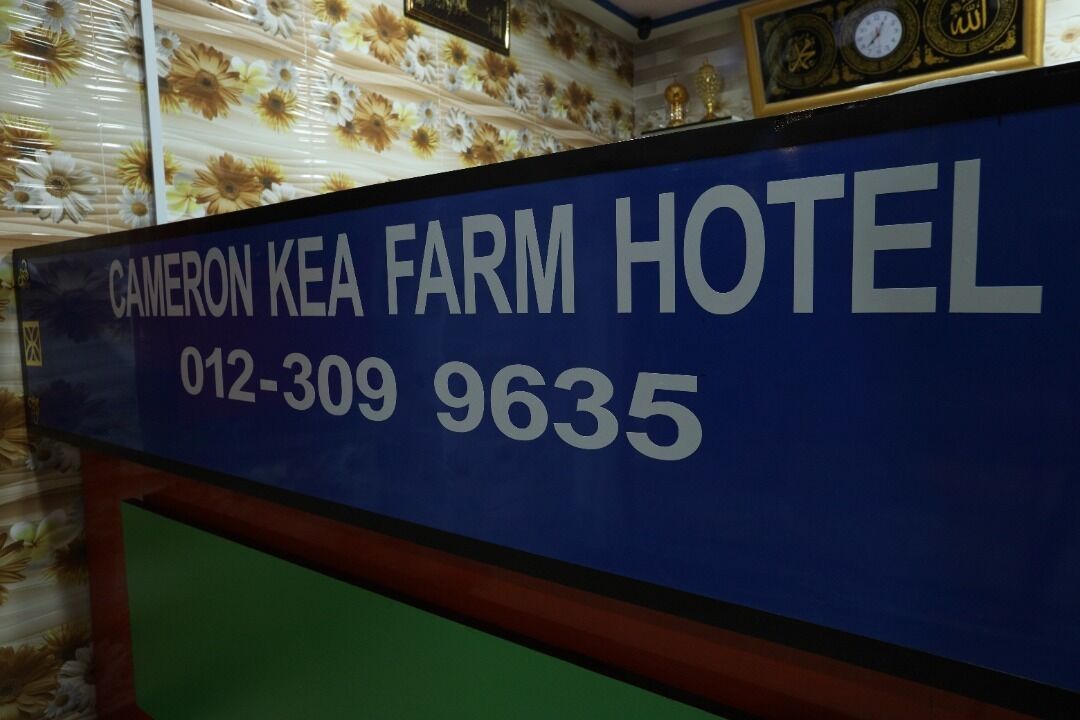 A sign for Cameron Kear Farm Hotel with the number 012-309 9635.