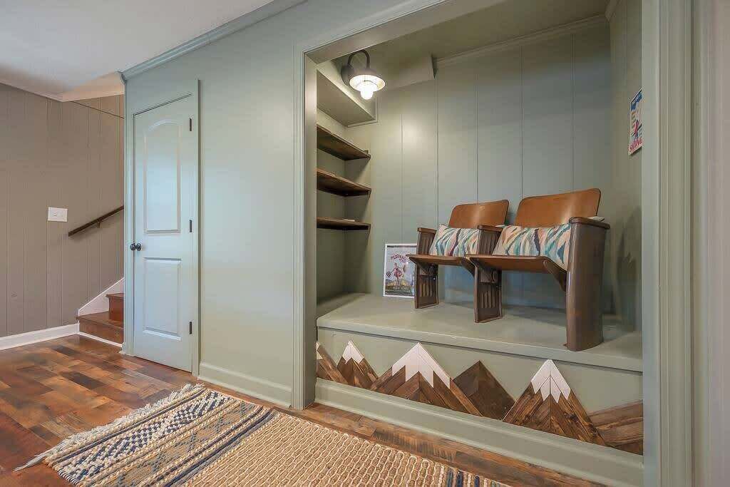 A hallway with a built-in bench, a door, and a staircase.