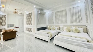 A hotel room with three beds, a chandelier, and patterned wallpaper. - Linh Phuong 6 (Can Tho)