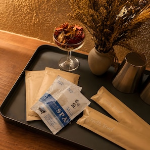 A tray with a glass of dried flowers, a vase with dried plants, and several packages labeled 'SPA' and 'Footh Truel'.