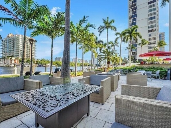 Relax in style amidst lush palm trees and a serene waterfront view.