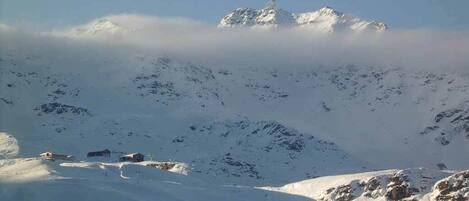 A snow-covered mountain landscape with a clear sky.