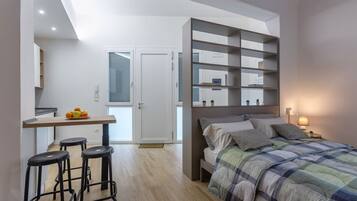 Tabla de planchar con plancha, internet y ropa de cama