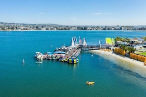 A marina with boats, a bridge, and a beach area.