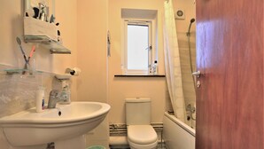 A bathroom with a sink, toilet, and shower.