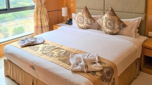 A hotel room with a large bed, a headboard, and a view of the countryside through the window. - HOTEL EXPRESS (Luanda)