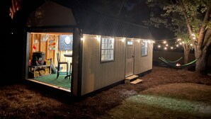 Un petit bâtiment d’un seul étage, doté d’un porche et d’une porte donnant sur l’intérieur.