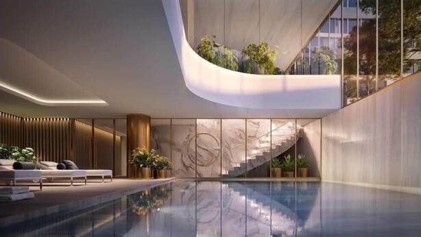 A modern indoor pool area with a glass ceiling, a seating area with a sofa and cushions, and a staircase leading to an upper level. - Modern Luxury 2B2B Sky Garden SmartTV (Glen Waverley)