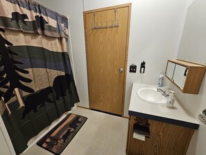 Bathtub, hair dryer, towels, soap