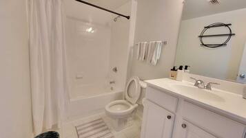 Combined shower/tub, hair dryer, towels, soap