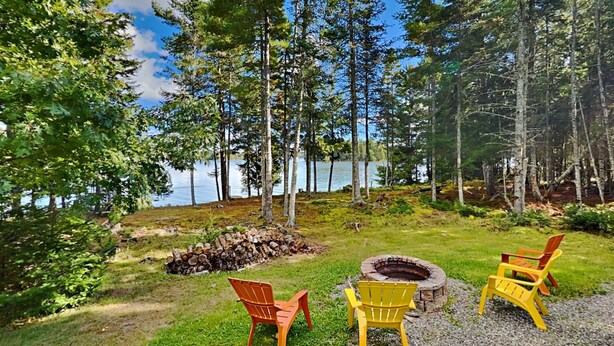 A lakeside outdoor seating area with a fire pit and Adirondack chairs. - Wolfe's Way Priv. Beach, Waterfront recreation, Swim & Acadia! (Franklin)