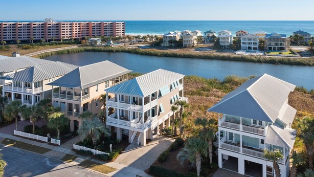 A coastal residential area with beachfront properties featuring balconies, a marina, and a large hotel in the background. - Aqua Easy - Destin Pointe, Gulf Views, Lakefront, Free Beach Service, Cmty Pool! (Destin)