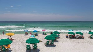 A beach with multiple green umbrellas and beach chairs, a clear sky, and the ocean in the background. - Aqua Easy - Destin Pointe, Gulf Views, Lakefront, Free Beach Service, Cmty Pool! (Destin)