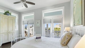 A bedroom with a large bed, a ceiling fan, and a view of the balcony. - Aqua Easy - Destin Pointe, Gulf Views, Lakefront, Free Beach Service, Cmty Pool! (Destin)
