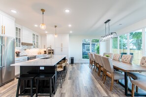 Enjoy meals in the kitchen with a large island, oven, and stainless steel refrigerator.