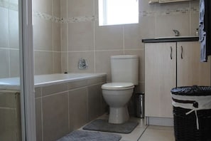 Bathtub, towels, soap, toilet paper