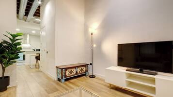 City Apartment, 1 Bedroom | Living area | 30-inch LCD TV with cable channels