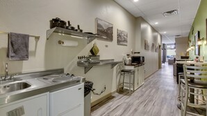 A modern kitchen with stainless steel appliances, a bar area, and a dining space. - 1892 suite at Ore House Inn (New Castle)