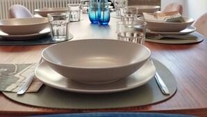 A dining table set with plates, bowls, glasses, and vases with flowers. - Apartment with kitchen-living room, 3 bedrooms, 2 bathrooms, laundry. (Bologna)