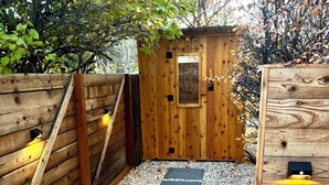 A wooden deck with a stone pathway leading to a wooden door. - Proper Luxury, Sauna, The Woodland Loft (Bozeman)