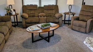 A living room with a brown sofa set, a coffee table with magazines, and two side tables with lamps. -  HARVEST COTTAGE Cozy home for family memories in a small town.. (Hesston)