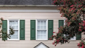A two-story building with a green door and white columns, numbered 106. - TigerTown Retreat - Comfort Minutes from Campus (Central)