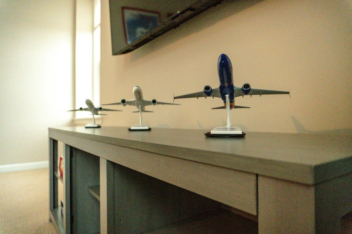 A display of model airplanes on a desk.