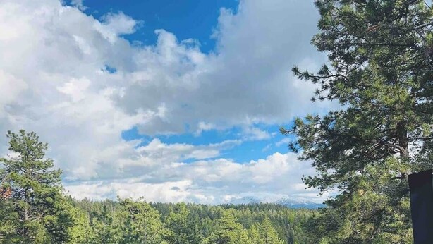 A hot tub with a view of a forest and mountains. - HOT TUB ~ 31 Acres ~Bring ATVs/Border Nat'l Forest (Teller County)