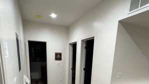A hallway with a dining area featuring a table and chairs. - Steps away from the slopes!  Recently built Scandinavian Cabin with Jacuzzi! (Beaver)