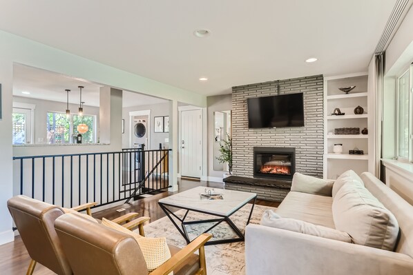 Smart TV, fireplace, books, computer monitors