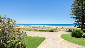 A coastal property with a paved driveway leading to a beach view. - Gorgeous Beach and Ocean Views - Located right on the Beach and Pet Friendly! (Moana)