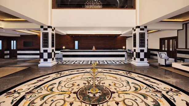 A lobby with a central reception desk, a chandelier, and a patterned floor. - Fortune Park, Hoshiarpur - Member ITC Hotels' Group (Hoshiarpur)