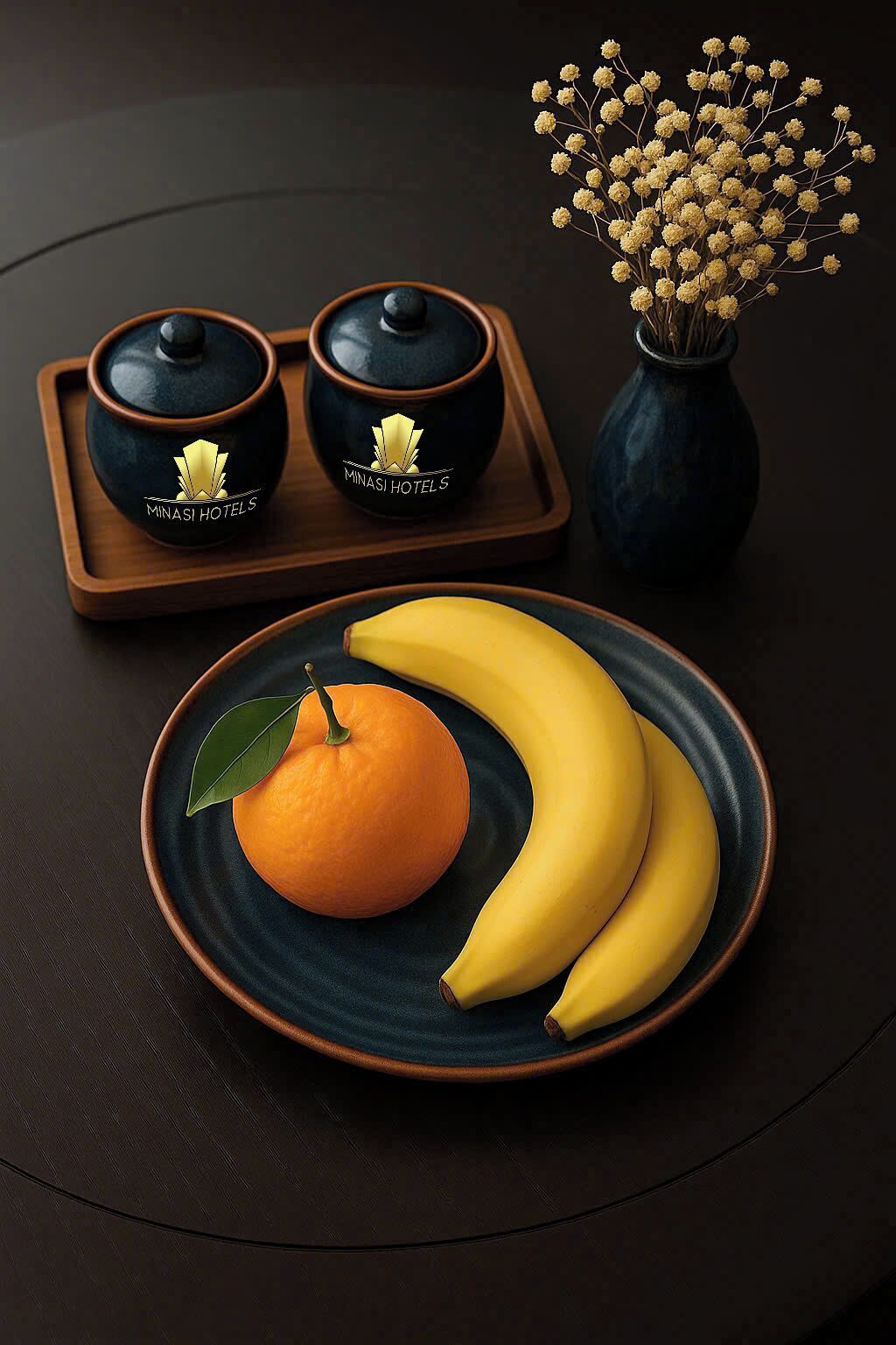 A tray with two black teapots and a vase with yellow flowers.