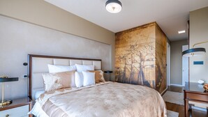 A bedroom with a large bed, a nightstand, a desk, and a wall with a map. - Villa Panorama (Crikvenica)