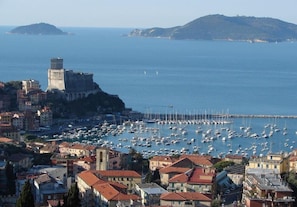 Overlooking a bustling marina, this coastal town features a historic fortification and traditional Mediterranean-style architecture.