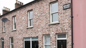 A brick building with a sign reading "Malone Place."