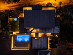 An aerial view of a residential property with a large house, a swimming pool, and a garage. - "Villa Bergen" Pool, Jacuzzi, Sauna, Fitness Center & Beach | 10 minutes from Bergen (Vestland)