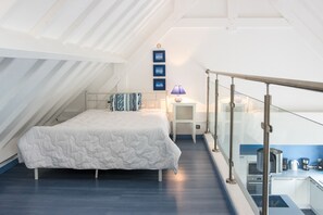 Relax in this stylish loft-style room with a large bed and modern amenities.