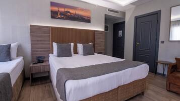Standard Triple Room | Minibar, in-room safe, desk, laptop workspace