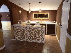 A kitchen with a central island, pendant lights, a mirror above the sink, and a decorative partition. - Private Tennis-Voleyball-Basketball, Heated Pool, Sauna with Aromatherapy (El Corral d'en Tort)