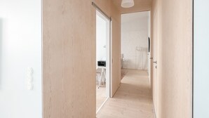A hallway with wooden flooring and a white ceiling light fixture. - 2ndhomes Luminous 2BR Loft House w Sauna (Helsinki)